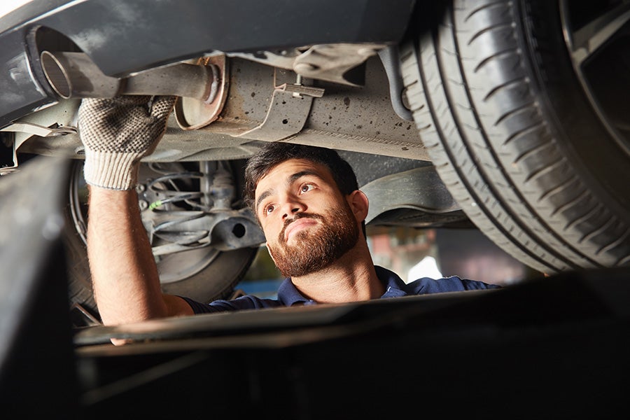 mechanic checking the car car-exhaust